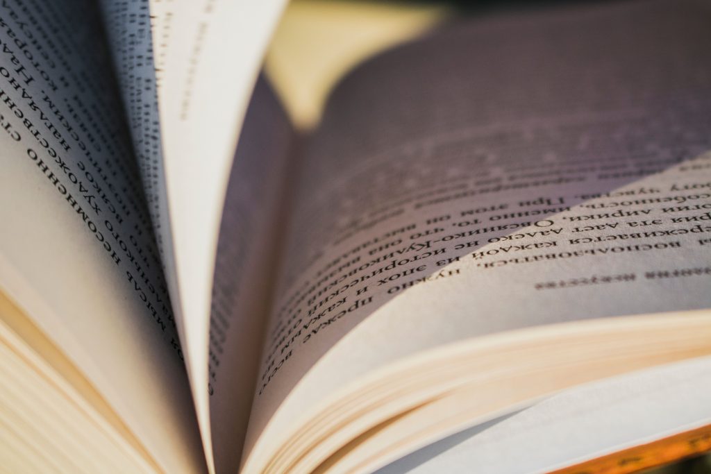 pexels photo 2410050 2410050 Detailed close-up image of an open book showing the textured pages and printed text.